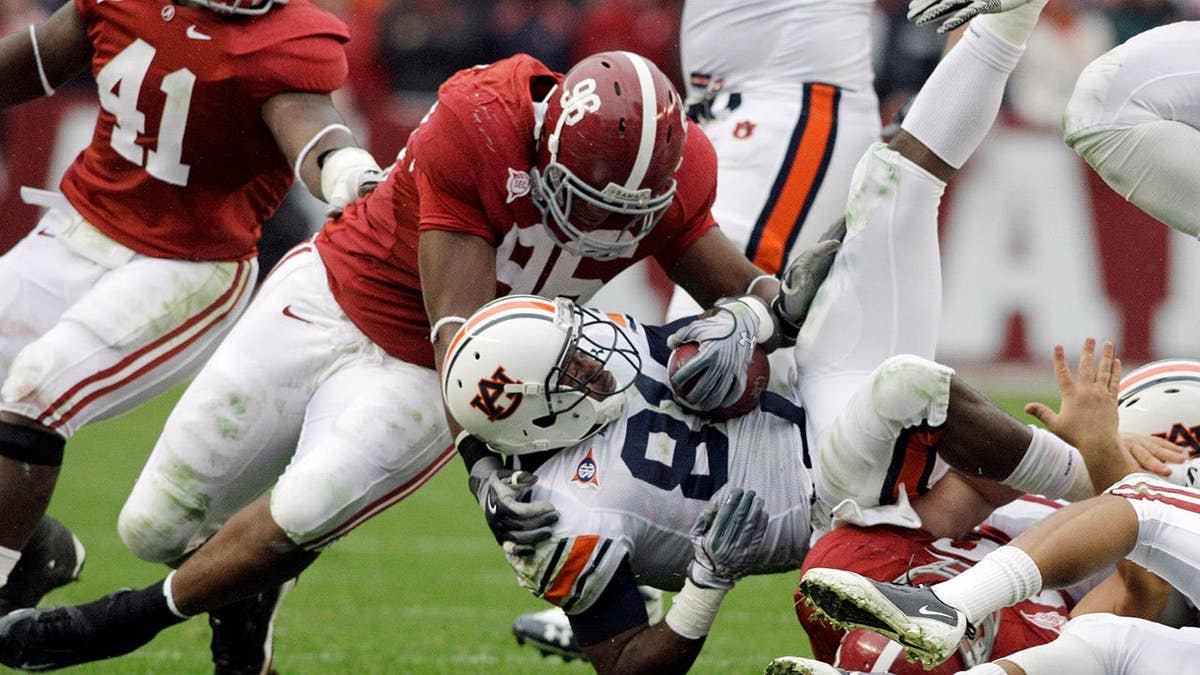 Alabama lineman Luther Davis tackles Auburn receiver Terrell Zachery at Bryant-Denny Stadium