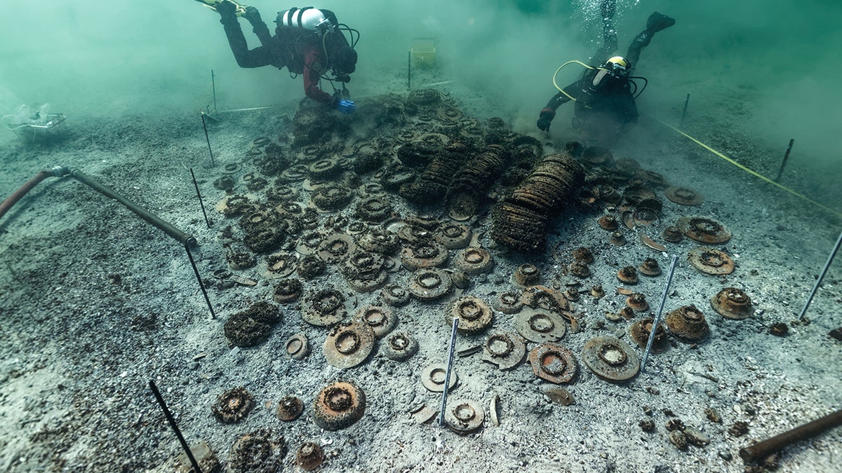 Archaeologists swimming near ceramics