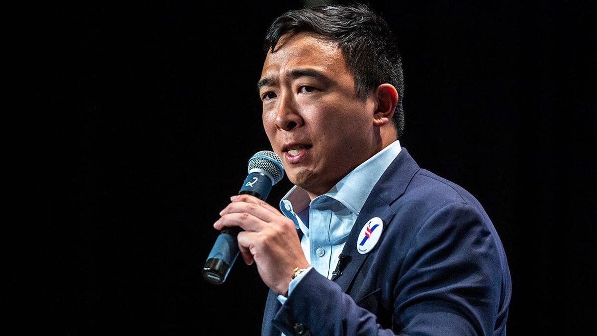 Democratic presidential candidate Andrew Yang speaking at a podium