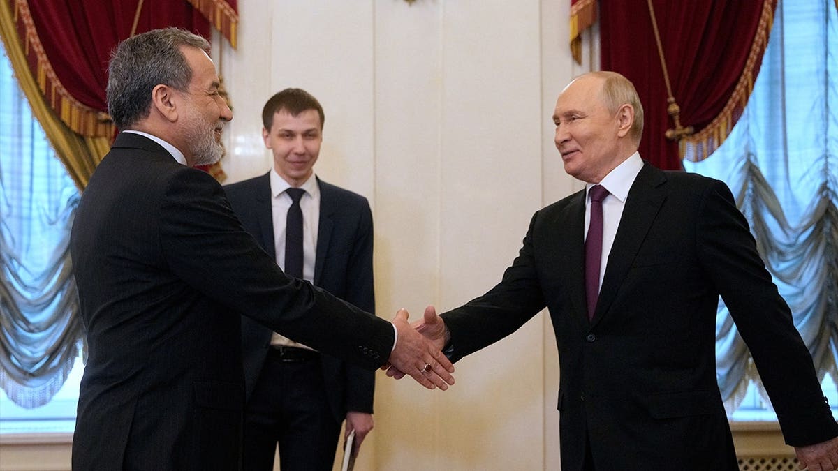 Russian President Vladimir Putin shook hands with Iranian Foreign Minister Abbas Araqchi