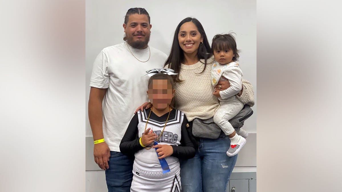 Anna, sus padres y su hermana mayor posan para una foto