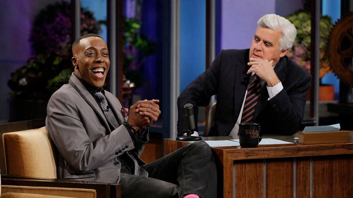 Comedian Arsenio Hall seated during an interview with host Jay Leno