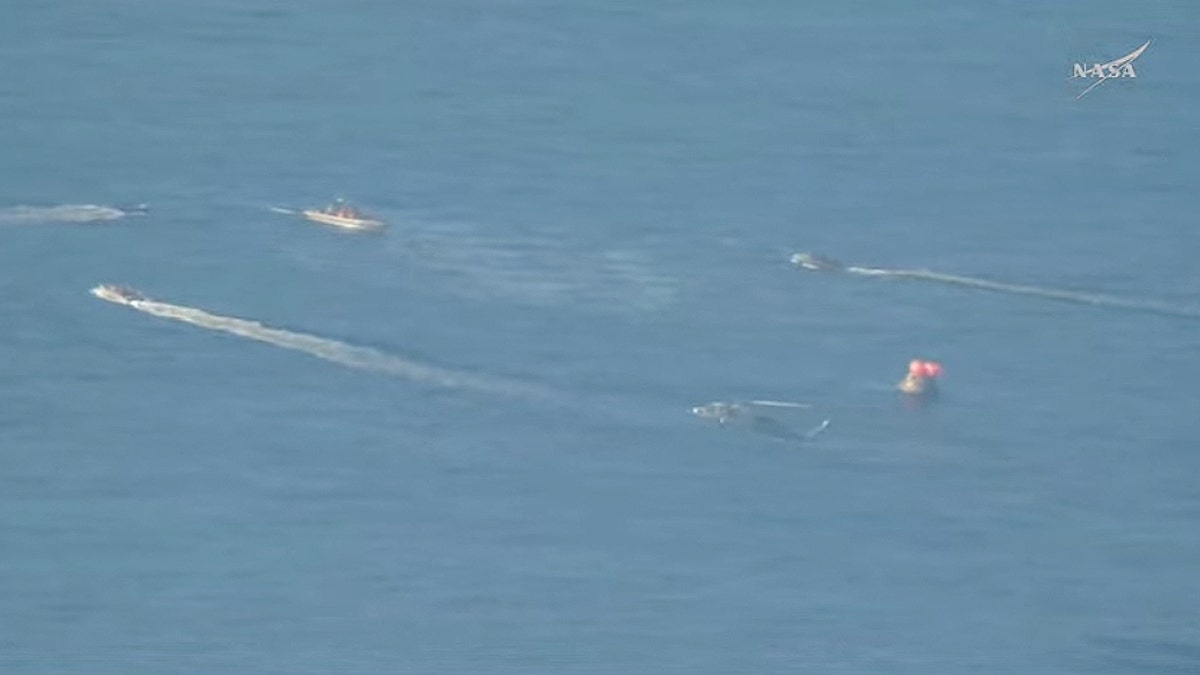 Recovery forces approach Artemis II after its splashdown off the coast of San Diego on Friday, April 10, 2026. (NASA)