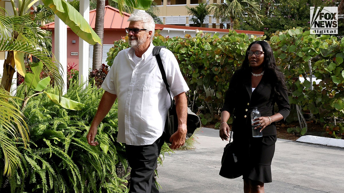 Brian Hooker leaving edifice  with lawyer   Terell A. Butler successful  Freeport, The Bahamas