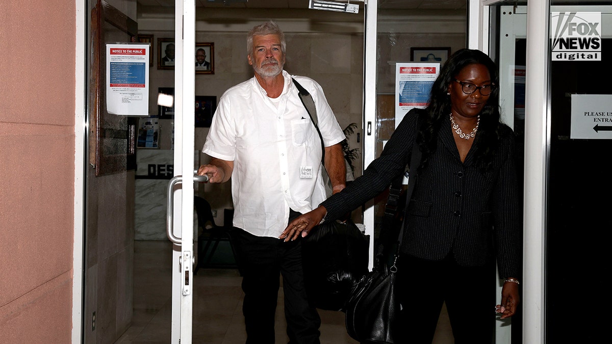 Brian Hooker leaves police station in The Bahamas, with lawyer