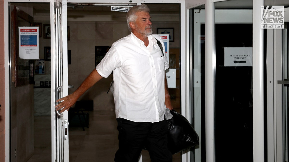 Brian Hooker leaves police station in The Bahamas, with lawyer