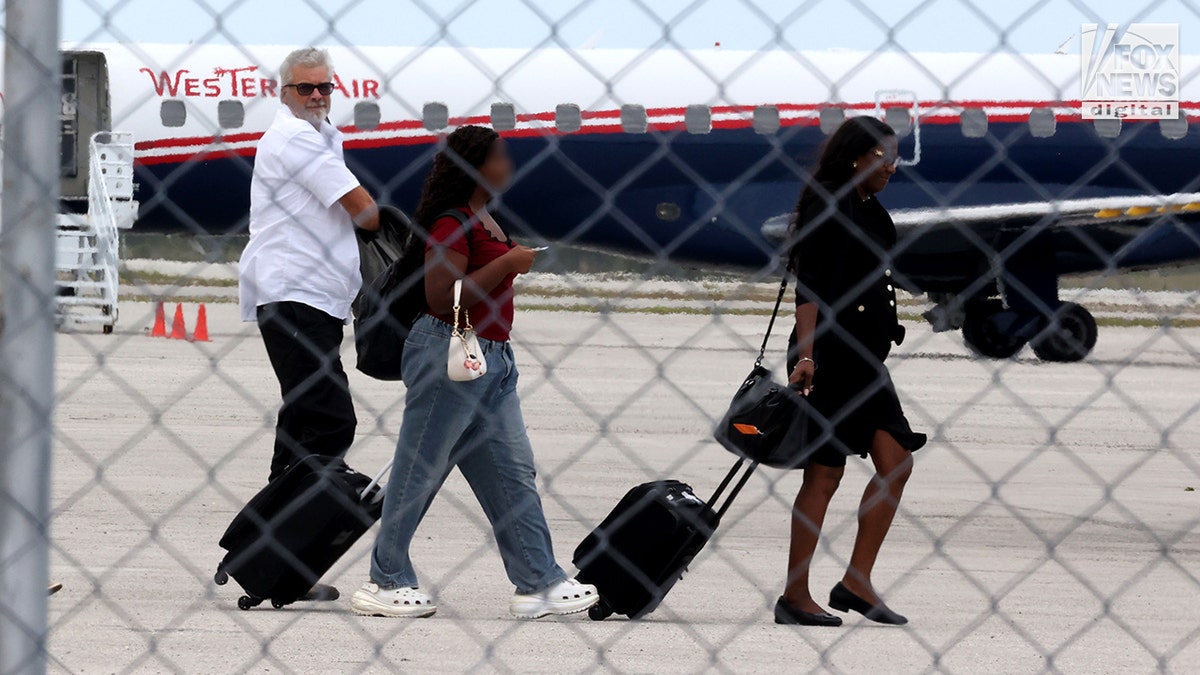 Brian Hooker and lawyer boarding a plane in The Bahamas