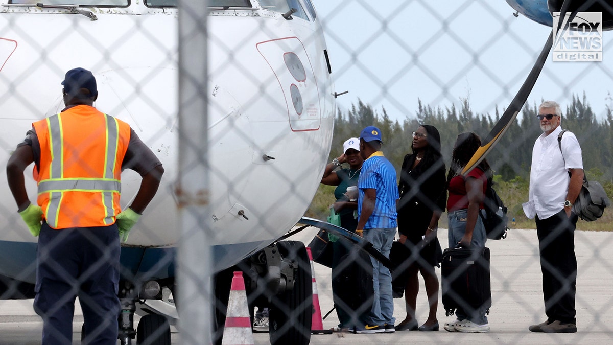 Brian Hooker and lawyer boarding a plane in The Bahamas