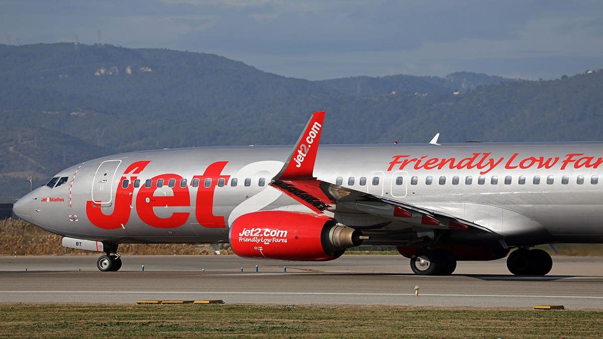 A Jet2 Boeing 737-883 airplane preparing for takeoff on a runway.
