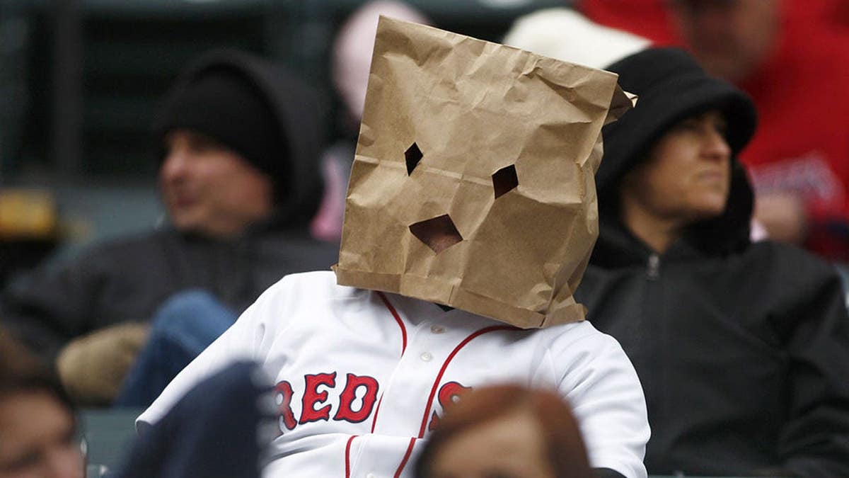 A Boston Red Sox fan wearing a paper bag over his head at Progressive Field in Cleveland