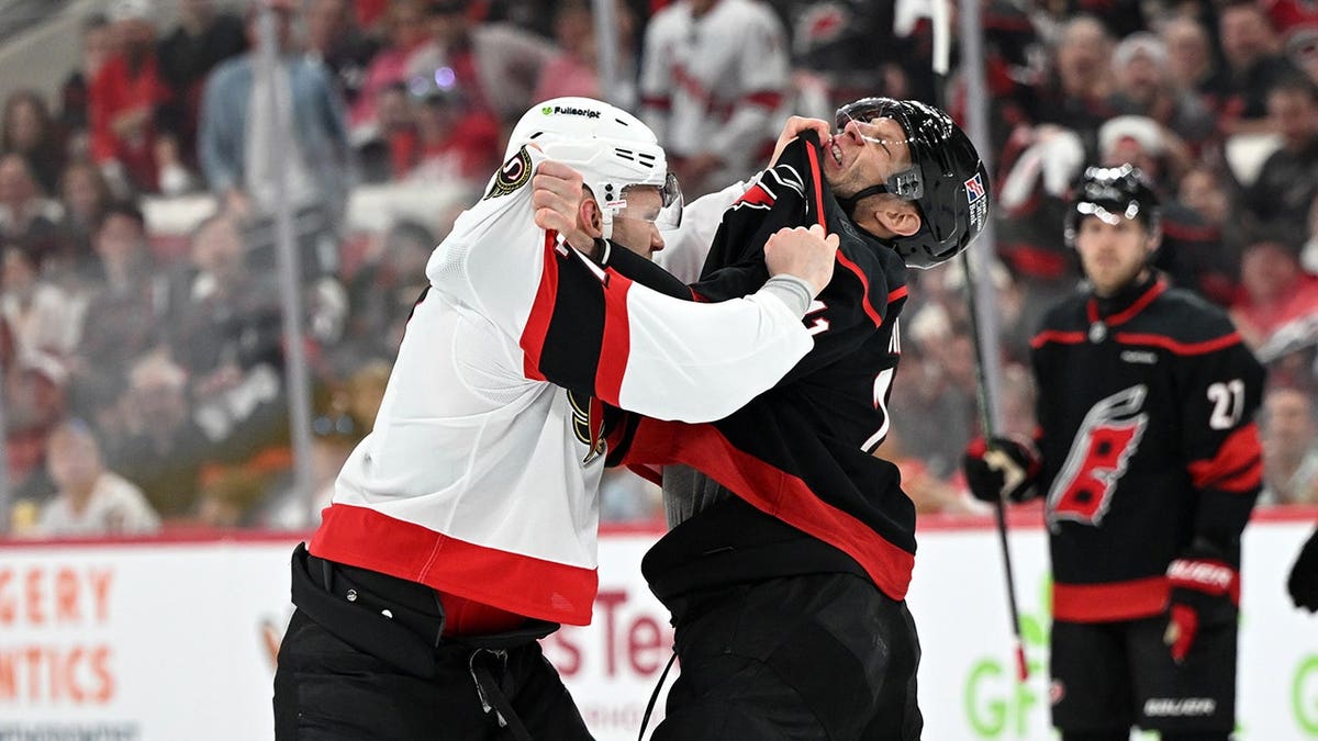 Brady Tkachuk and Jordan Staal fighting during NHL Stanley Cup Playoffs game.