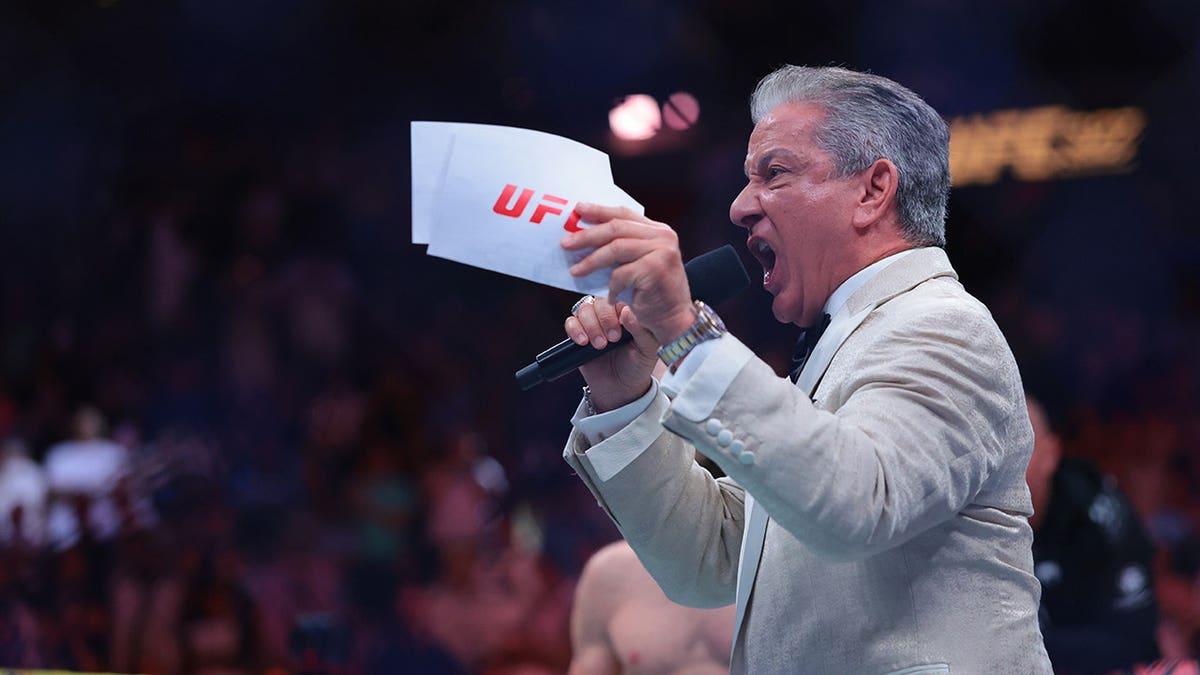 UFC announcer Bruce Buffer standing in the Kaseya Center arena.
