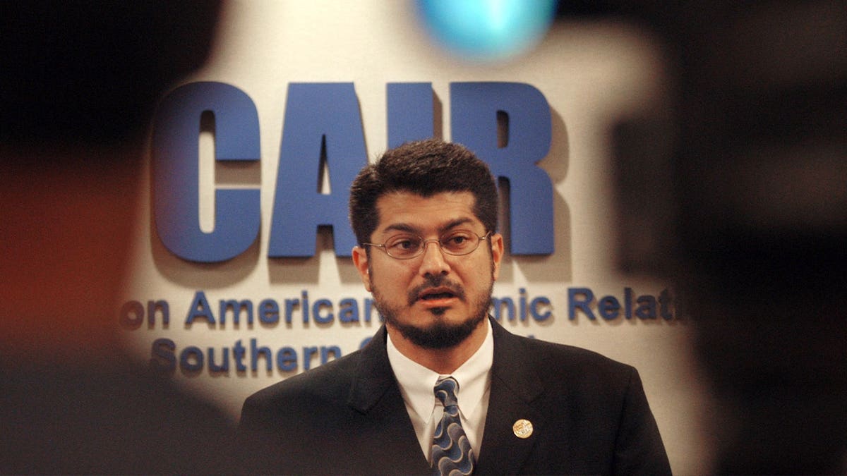 Hussam Ayloush speaks in a suit