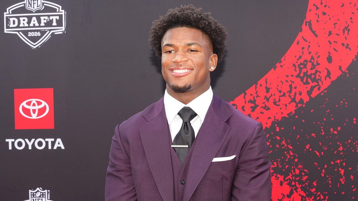 Ohio State Buckeyes defensive back Caleb Downs posing on red carpet at Point State Park