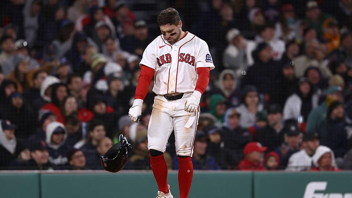 Caleb Durbin of the Boston Red Sox throws down his helmet at Fenway Park.
