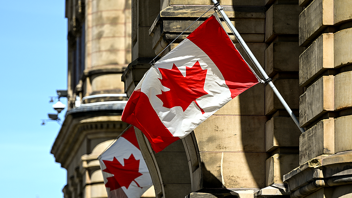 Two Canadian flags flying outside the Prime Minister's office in downtown Ottawa, Ontario, Canada
