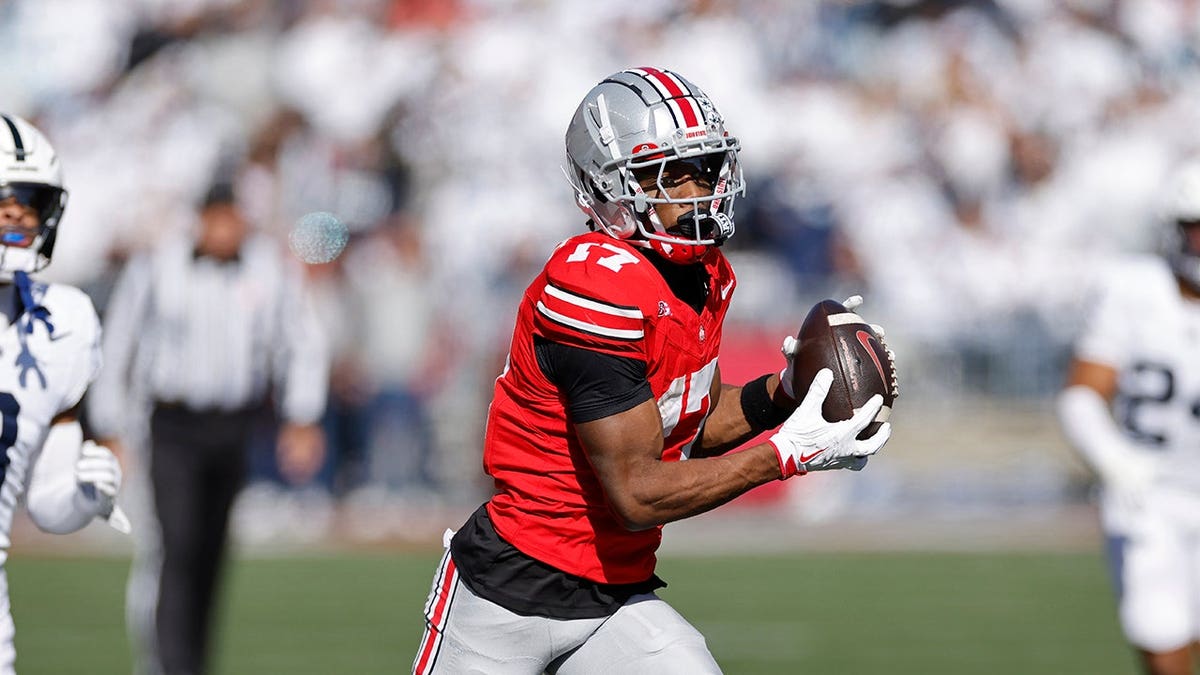 Carnell Tate catching a football during a game at Ohio Stadium in Columbus, Ohio