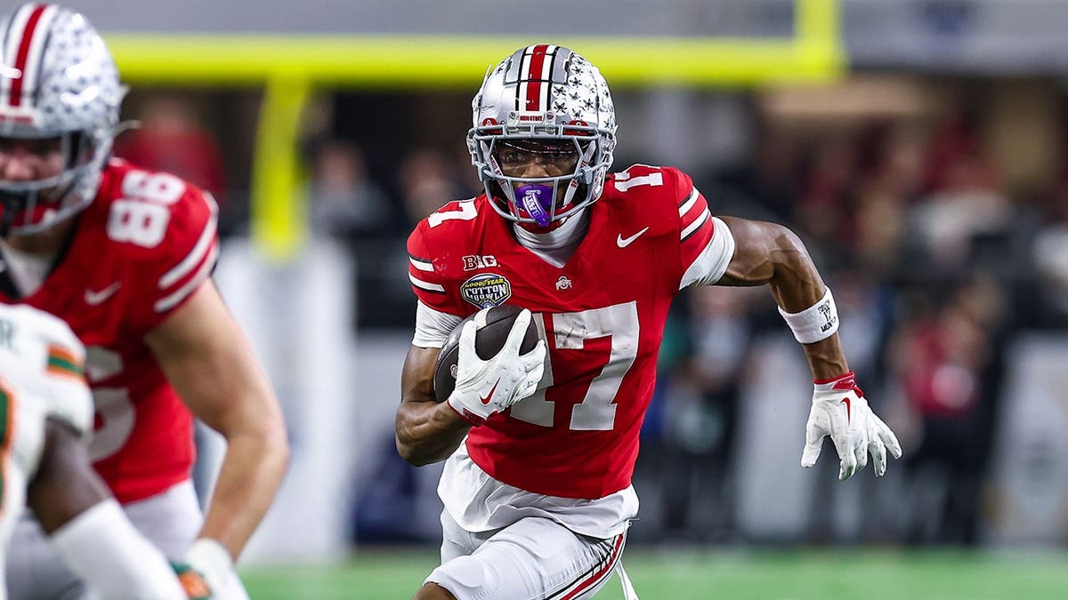 Ohio State wide receiver Carnell Tate running up field after a catch at AT&T Stadium