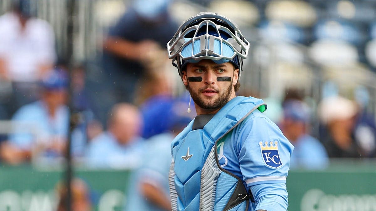 Carter Jensen wearing Kansas City Royals uniform looking on during baseball game