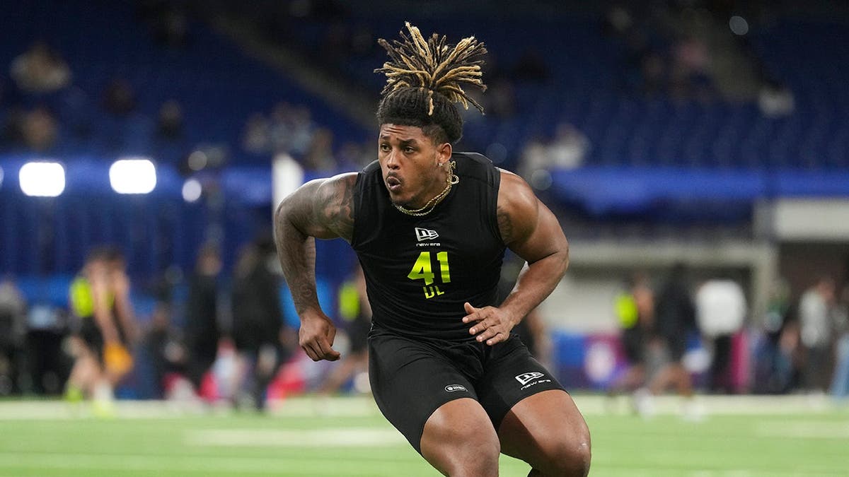 Texas A&M defensive lineman Cashius Howell doing drills during the NFL Scouting Combine at Lucas Oil Stadium in Indianapolis.