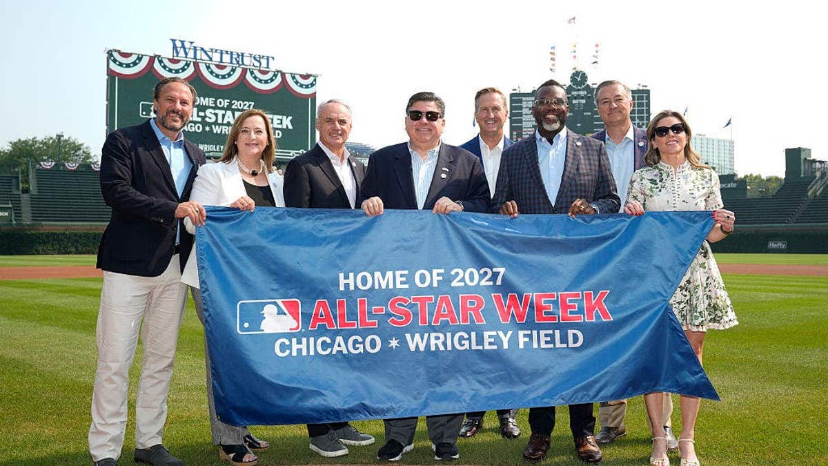 Todd Ricketts Laura Ricketts Rob Manfred JB Pritzker Crane Kenney Brandon Johnson Tom Ricketts Kara Bachman posing at Wrigley Field