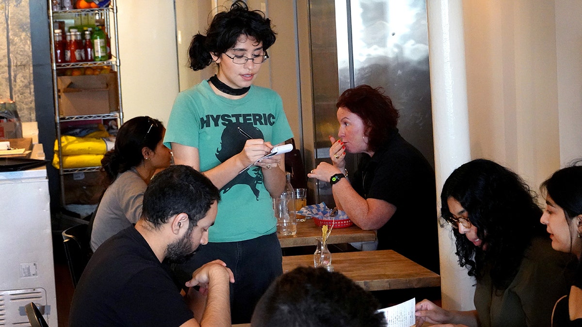 A Chicago waitress writes down an order at the Same Day Cafe.