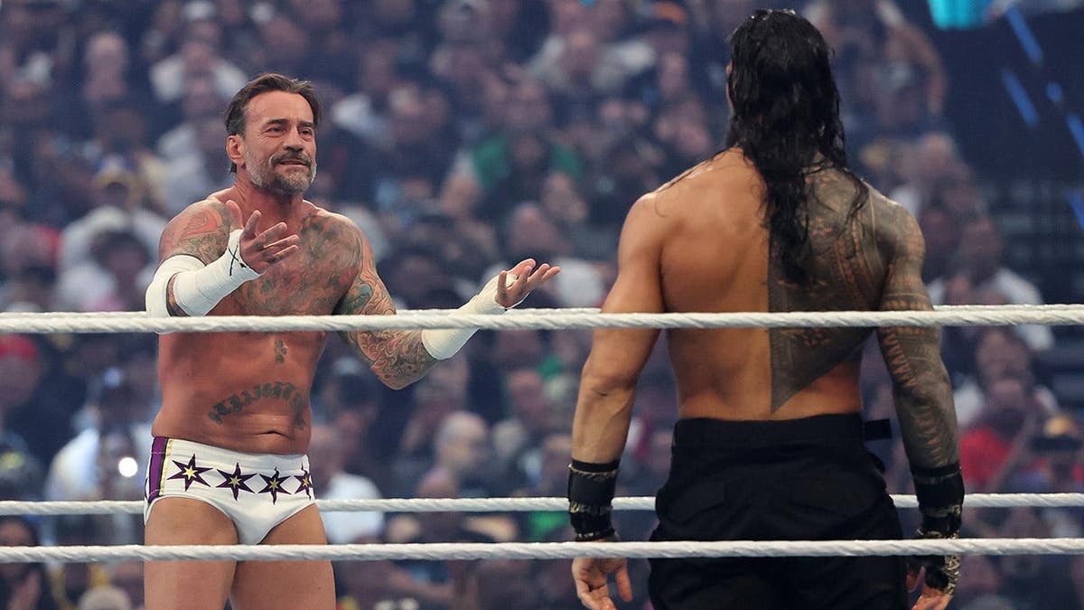 CM Punk reacts to Roman Reigns before World Heavyweight Championship match at Allegiant Stadium