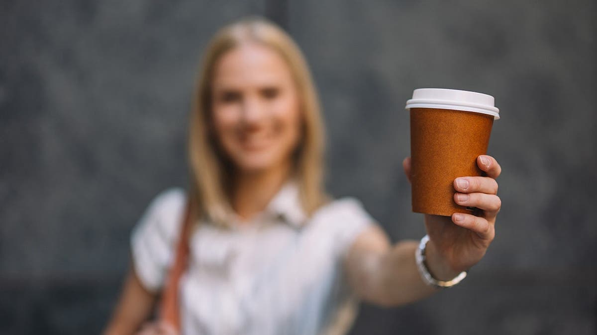 Lady holding coffee cup