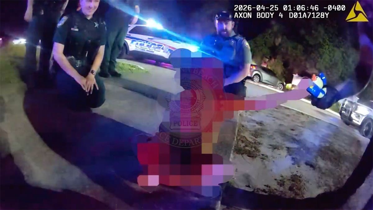 Officers comforting a child while Cory Acree is taken into custody in Daytona Beach