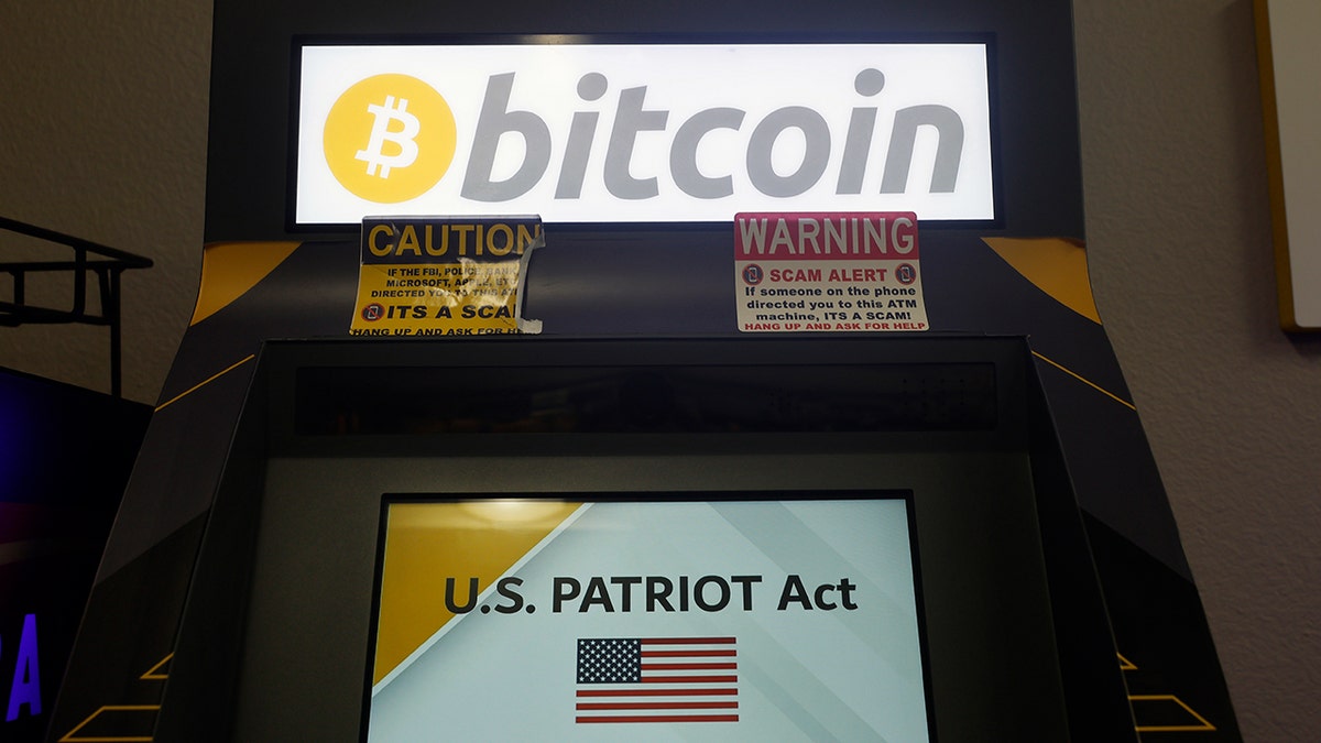 A bitcoin machine has "U.S. PATRIOT Act" on the screen.