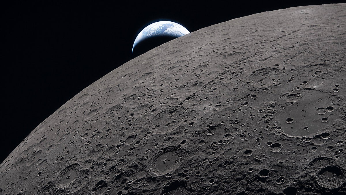 The Artemis II crew captures Earth setting behind the Moon during a lunar flyby.