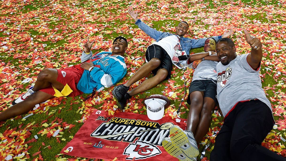 Kansas City Chiefs defensive back coach Dave Merritt celebrating with his sons at Hard Rock Stadium