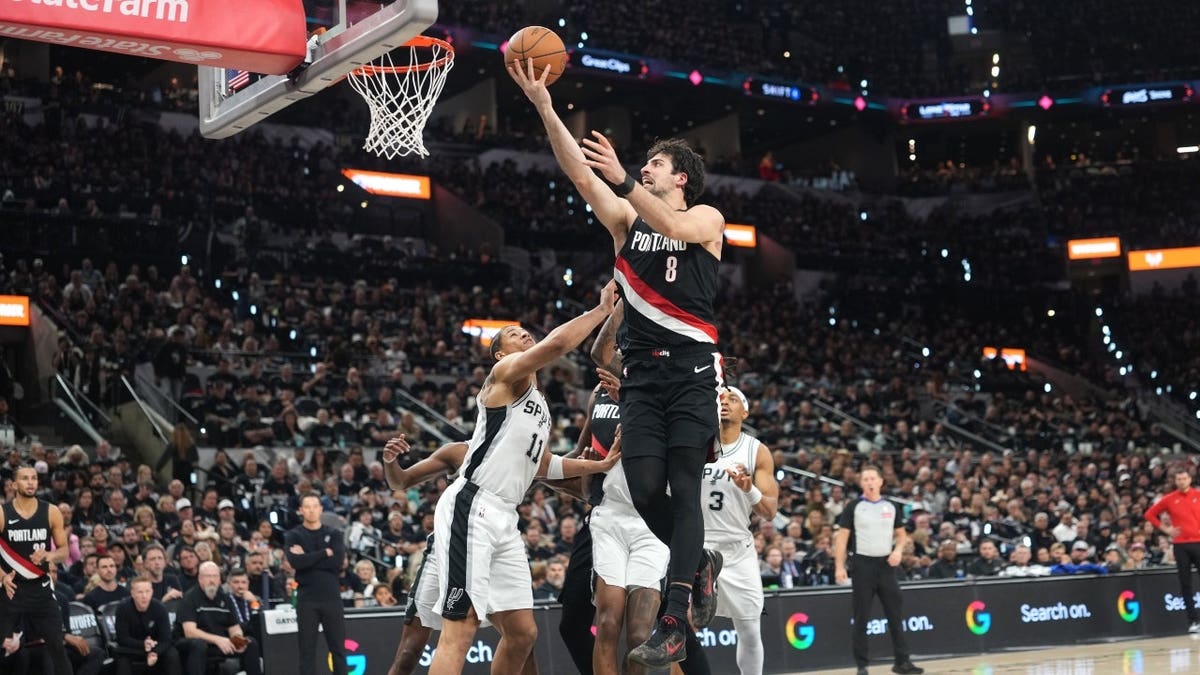 Portland Trail Blazers forward Deni Avdija gets to the rack vs. San Antonio Spurs forward Carter Bryant in Game 2 of their first-round series in the 2026 NBA Playoffs at Frost Bank Center.