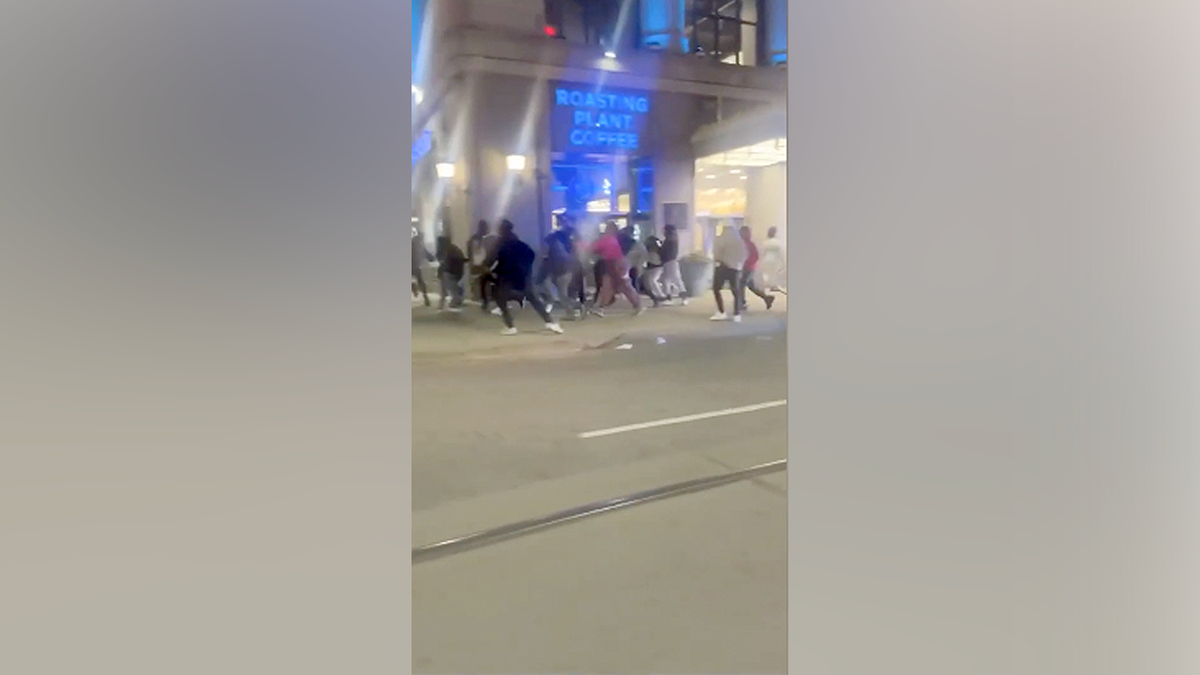 Teens gather in downtown Detroit streets during a