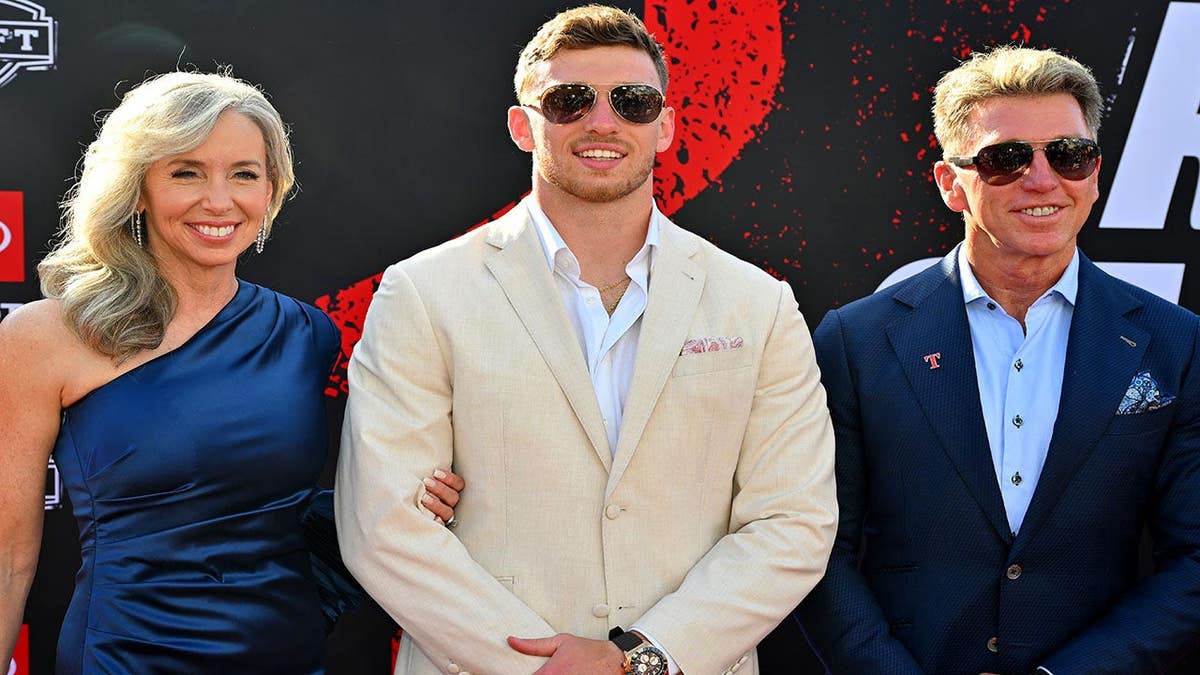 Dillon Thieneman posing with Ken Thieneman and Shannon Thieneman at NFL Draft in Pittsburgh