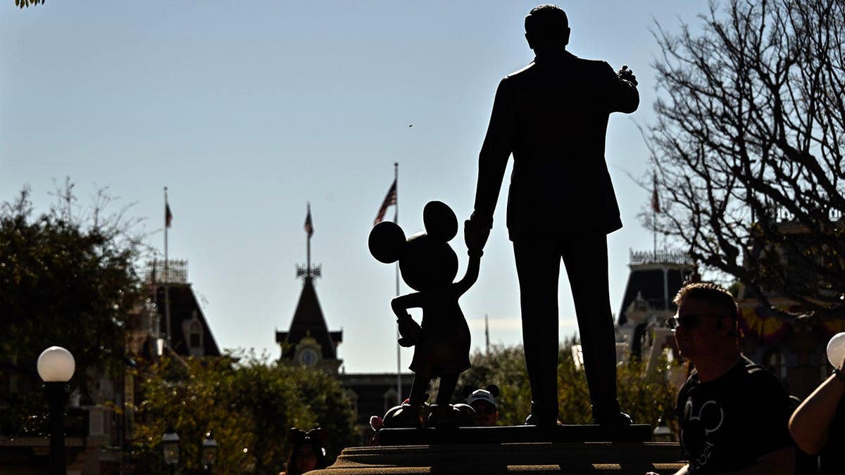 Statue of Walt Disney holding Mickey Mouse's manus  extracurricular  Sleeping Beauty Castle astatine  Disneyland