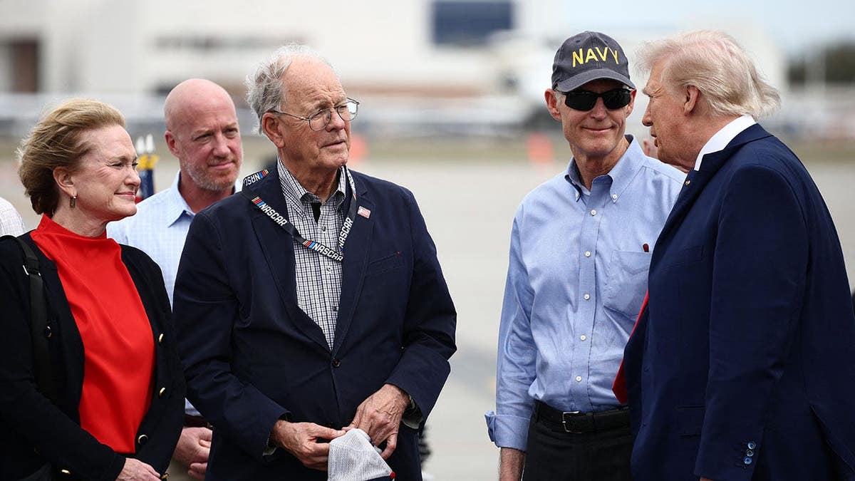 US President Donald Trump greeted by NASCAR Chairman Jim France and Sen. Rick Scott at Daytona International Speedway