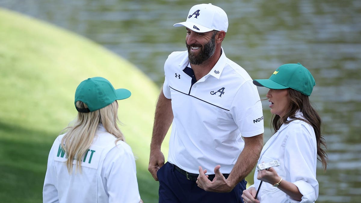 Nicole Willett talking with Dustin Johnson and Paulina Gretzky connected  the ninth greenish  astatine  Augusta National Golf Club