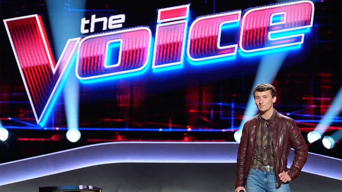 Dylan Carter singing on The Voice stage during blind auditions