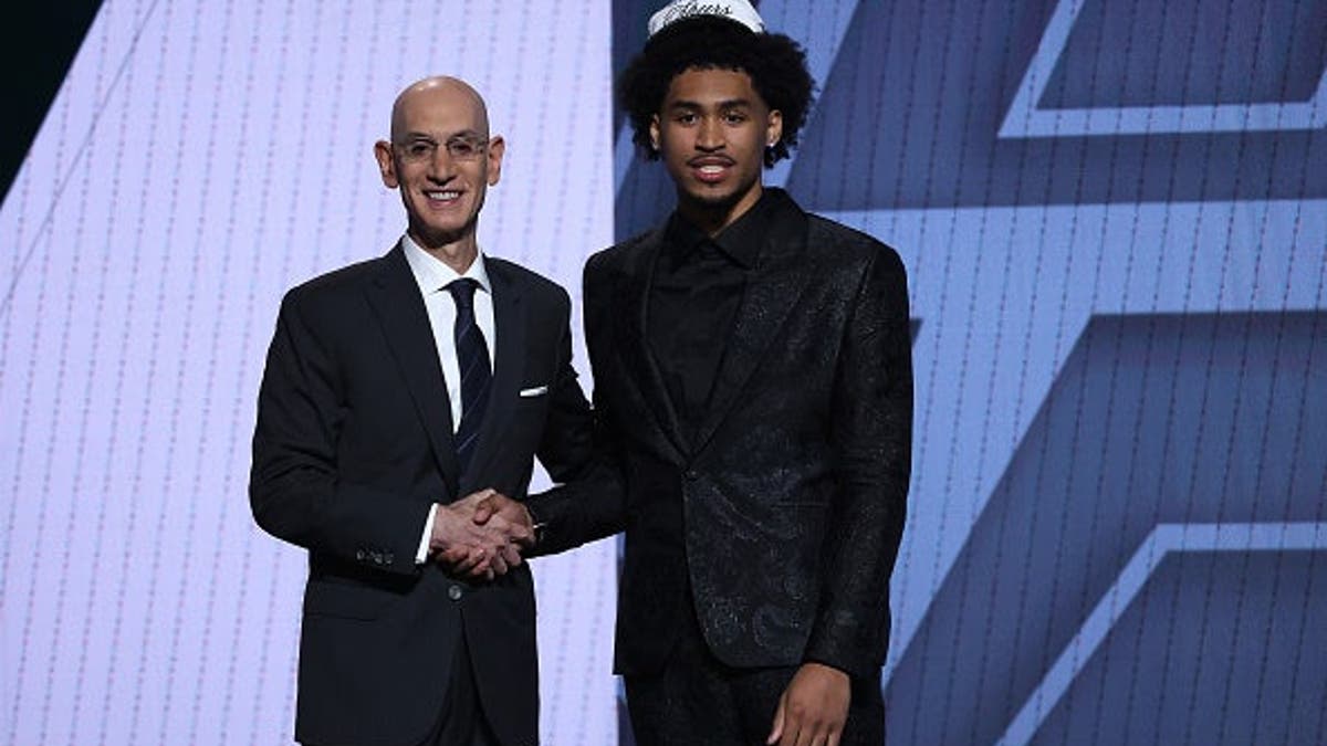 Dylan Harper shaking hands with NBA commissioner Adam Silver at Barclays Center