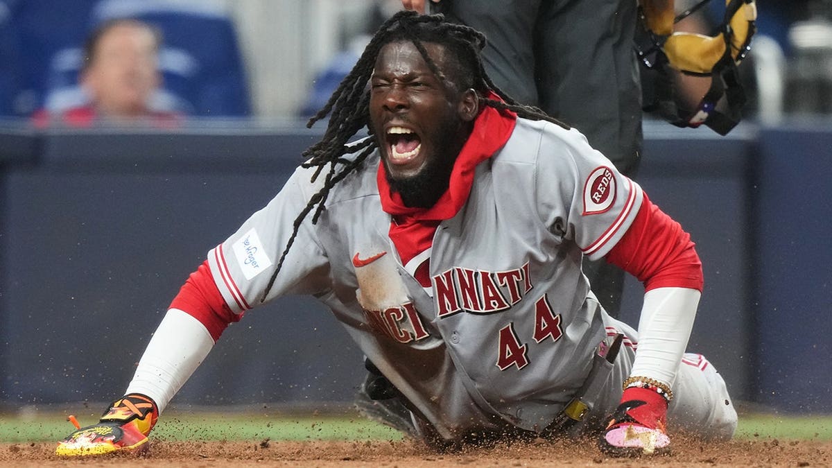 Cincinnati Reds' Elly de la Cruz reacting after scoring during a baseball game.