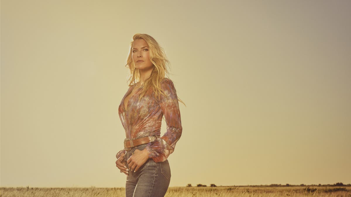 Ali Larter portraying Angela Norris standing in a scene from Landman season 2.