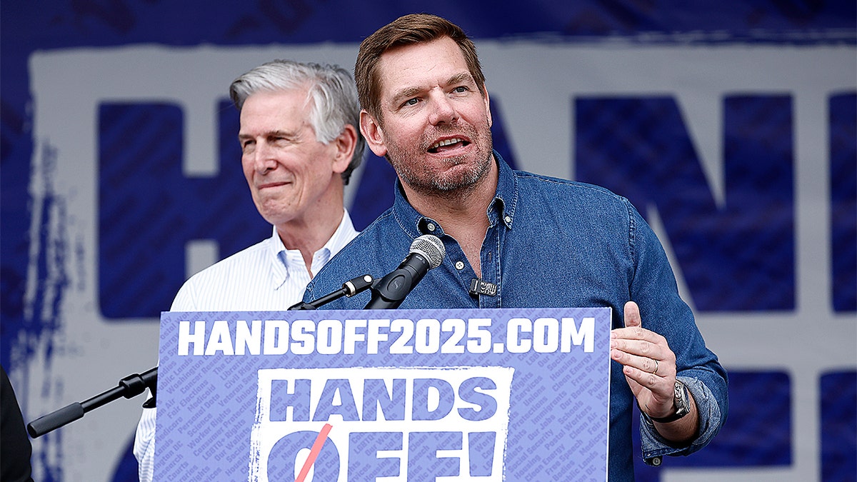 Eric Swalwell speaking at a podium during an outdoor event in Washington, D.C.