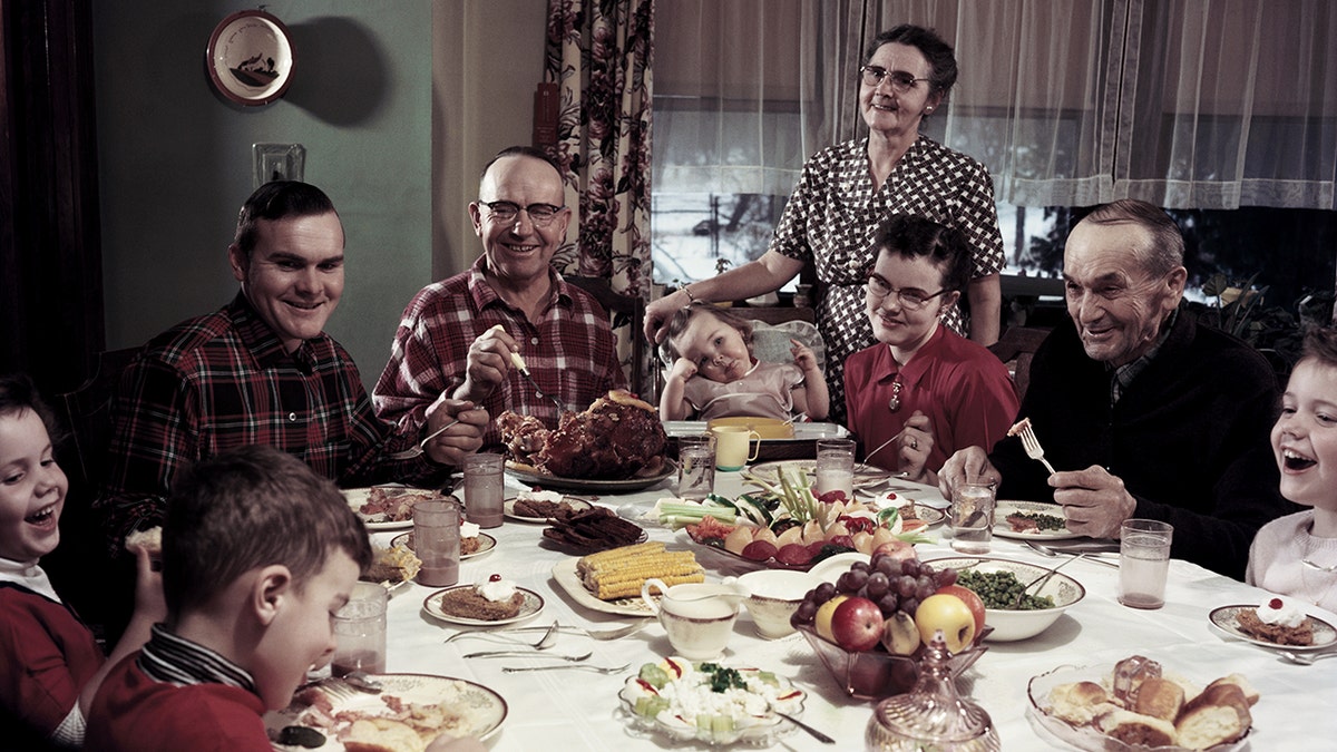 A family gathers at the dinner table in 1955.