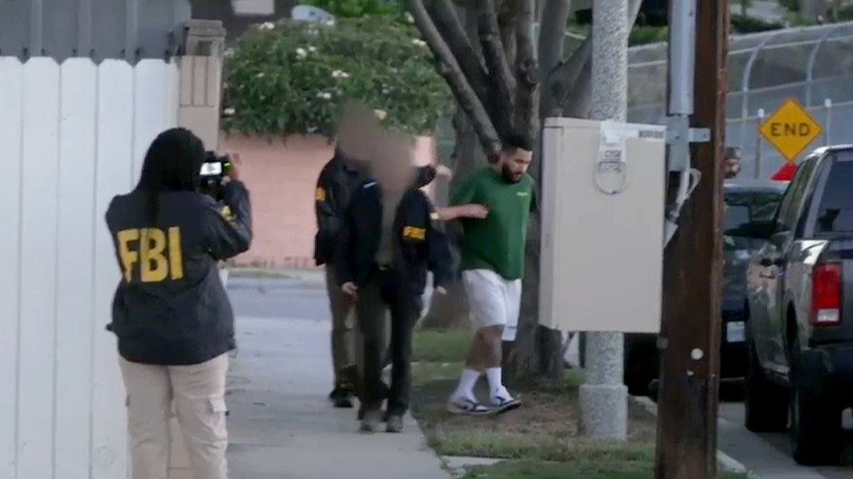 FBI agents escort suspected Mexican Mafia subordinate   during aboriginal  greeting  apprehension  successful  Orange County