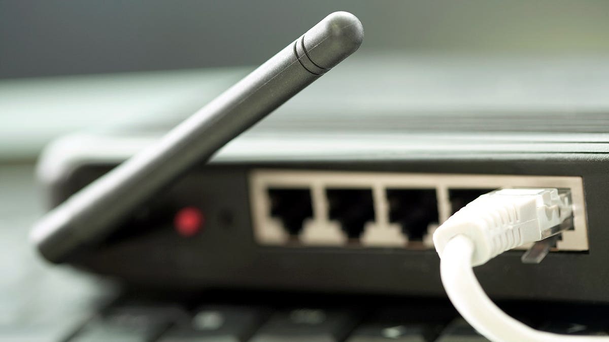 A wire runs out of a Wi-Fi router.