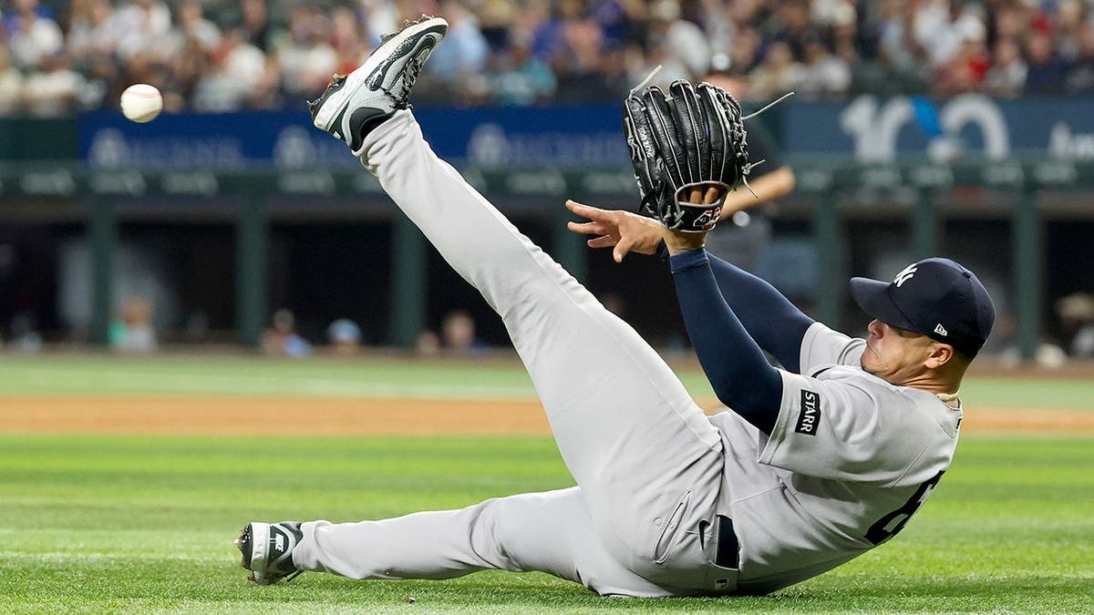New York Yankees relief pitcher Fernando Cruz fields a ground ball and throws to third base at Globe Life Field