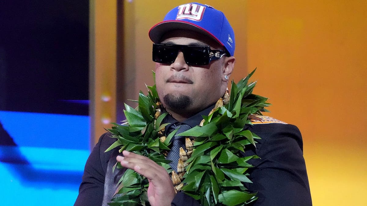 Miami offensive lineman Francis Mauigoa reacts after being chosen by the New York Giants at NFL draft