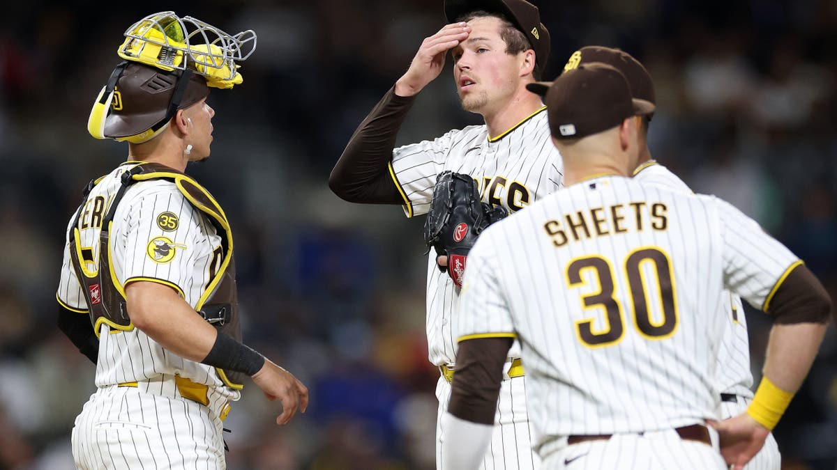 Freddy Fermin and Gavin Sheets approaching the mound as Mason Miller looks on at Petco Park