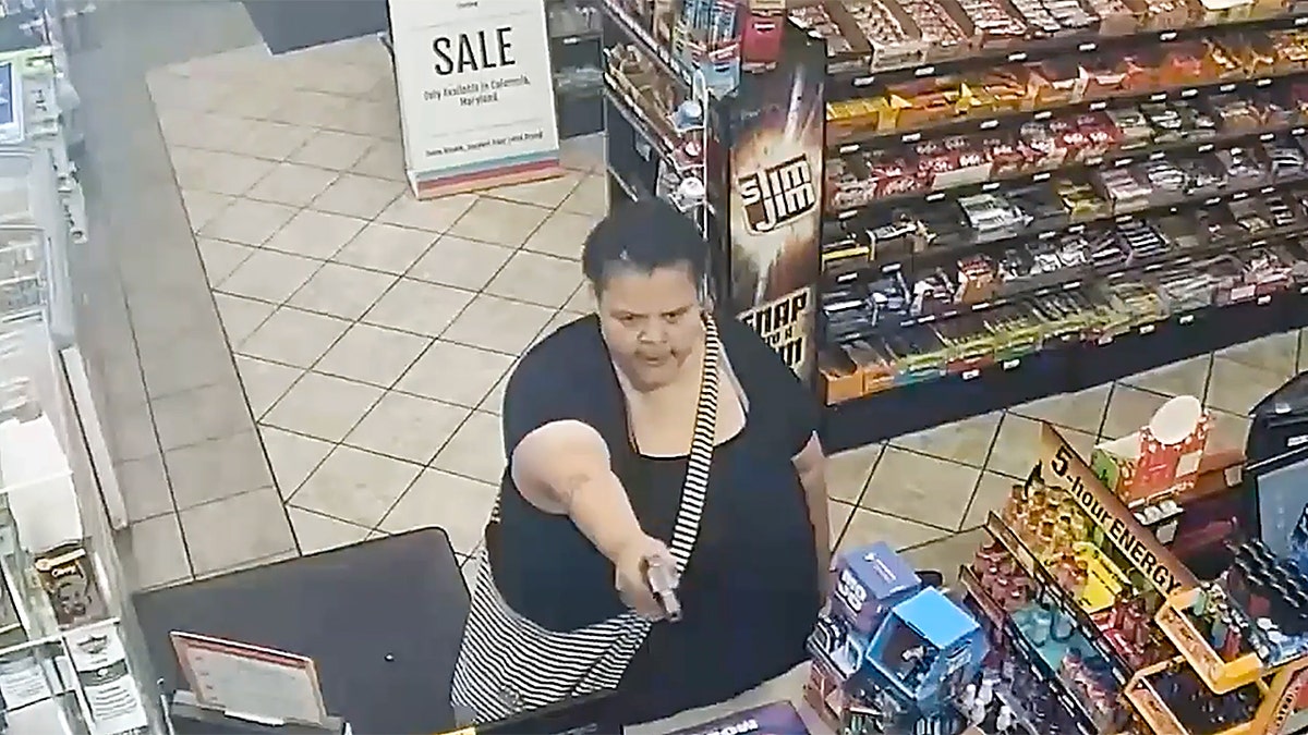 Woman holds gun